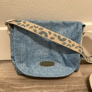 Keen blue crossbody bag with a patterned nylon adjustable strap. Outdoors travel